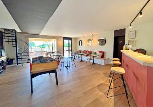 a living room with a table and some chairs at Camping Rouffignac-St-Cernin in Ladeymarie