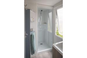 a bathroom with a shower and a sink at Camping Rouffignac-St-Cernin in Ladeymarie +12 photos