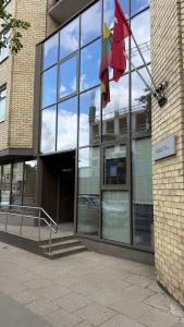 two flags are flying outside of a building at Algirdo Sunlight Studio in Vilnius