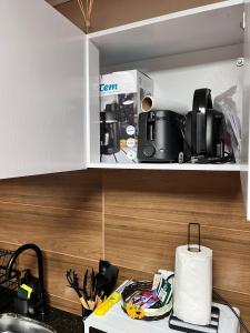 a kitchen with a microwave and some appliances on a shelf at Carmelo House in Carmelo