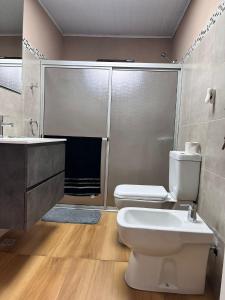 a bathroom with a toilet and a sink at Carmelo House in Carmelo