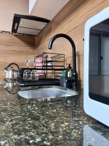 a kitchen counter with a sink and a sink at Carmelo House in Carmelo