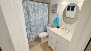 a bathroom with a shower and a toilet and a sink at Serenity by the Sea - Vilano Beach in Saint Augustine +68 photos