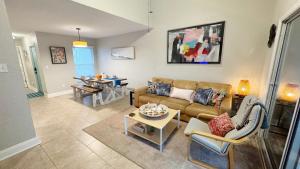 a living room with a couch and a table at Serenity by the Sea - Vilano Beach in Saint Augustine