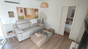 a living room with a couch and a table at Apartamento EL REAL - Espartinas - SEVILLA in Espartinas