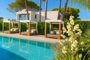 a villa with a swimming pool and a house at Rosemarine Villas in Durrës