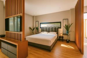 a bedroom with a bed and a television in it at Rosemarine Villas in Durrës +33 photos