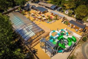 an aerial view of an amusement park with a water slide at Camping Hourtin in Hourtin