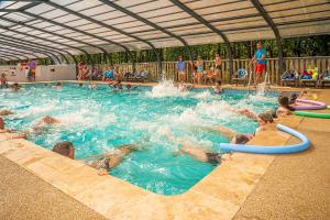 a group of people in a swimming pool at Camping Hourtin in Hourtin +11 photos