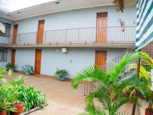 an empty courtyard of a building with plants at Nguruma house of travellers and tours in Arusha