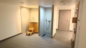 a bathroom with a sink and a wooden stool at Apartament Ski&Bike Czarna Góra, Sienna in Sienna