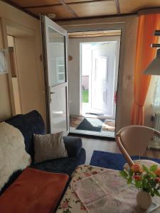 a living room with a couch and a sliding glass door at Ferienhaus Bützow in Güstrow
