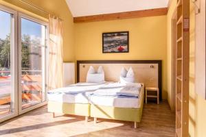 a bedroom with a bed and a large window at Ferienwohnung mit Seeblick - Fischerhafen Plauer See in Plau am See