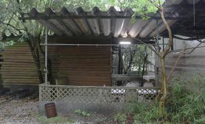 a wooden shelter with a tree in a yard at Shinfuji Auto Campsite - Vacation STAY 53263v in Kami-ide +3 photos