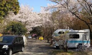 a car parked next to a trailer and a camper at Shinfuji Auto Campsite - Vacation STAY 53263v in Kami-ide