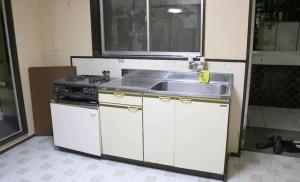 a kitchen with a sink and a stove at Shinfuji Auto Campsite - Vacation STAY 53263v in Kami-ide
