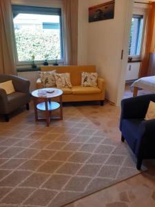 a living room with a couch and a table at Haus Gori in Haffkrug