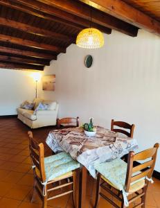 a dining room with a table and chairs and a couch at Terrazze al centro in Palermo