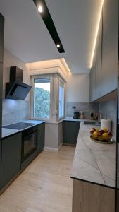 a kitchen with a counter with a bowl of fruit on it at The Central Spot, Mostar in Mostar