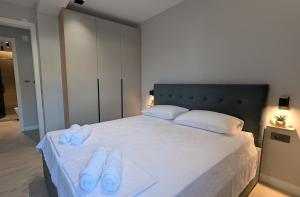 a bedroom with a large bed with blue towels on it at The Central Spot, Mostar in Mostar +6 photos