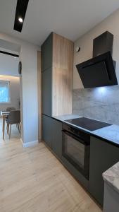 a kitchen with a stove and a counter top at The Central Spot, Mostar in Mostar