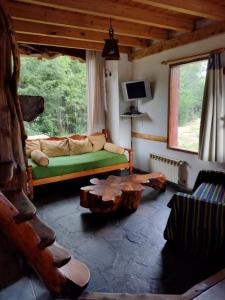 a living room with a couch and a table at Cipresales in Villa La Angostura