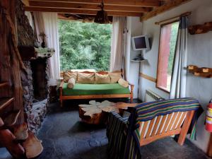 a living room with a couch and a table at Cipresales in Villa La Angostura