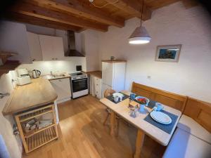 an overhead view of a kitchen with a table and a counter at Ferienwohnung Theresia Oberm, Kreuth-Enterbach in Kreuth +5 photos
