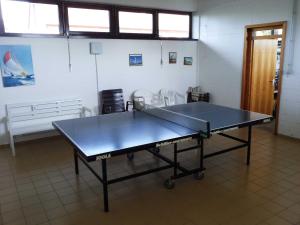 a ping pong table in the middle of a room at Ferienwohnung Ostseeglück in Schönhagen