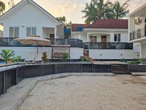 ダル・エス・サラームにあるSerene BnB - Apt 03 Makongo after Mlimani Cityの家の前にプールがある家