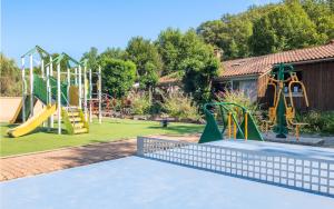 a playground with a slide and a slide at Camping Tamniès in Tamniès