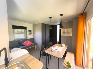 a living room with a couch and a table at Camping Tamniès in Tamniès +21 photos