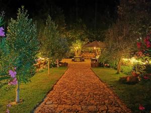 a cobblestone path in a garden at night at Agriturismo Tuluschene in Gavoi