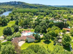 an aerial view of a house with a pool and trees at Camping Saint-Sozy in Saint-Sozy