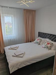 a bedroom with a bed with towels on it at Dani-Mihaela in Jurilovca