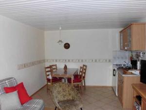 a kitchen and dining room with a table and chairs at Besch, Antje in Ueckeritz