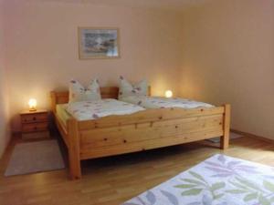 two beds in a bedroom with two candles on them at Besch, Antje in Ueckeritz +1 photo