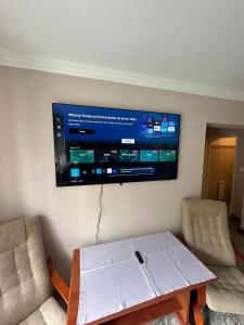 a flat screen tv on a wall in a living room at Willa Rudno Nad Jeziorem in Rudno