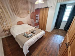 a bedroom with a bed with a table on it at Charmant T2 avec Loggia vue montagne in Laruns