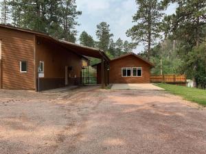 a barn with a large driveway in front of it at Rock Lodge Complete with Covered Parking in Keystone