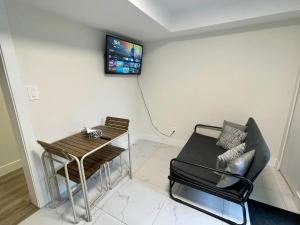 a living room with a couch and a table at Budget friendly 2-Bed 1-Bath Suite in New Westminster
