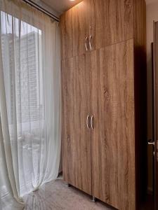 a large wooden cabinet in a room with a window at Blue Horizon in Batumi