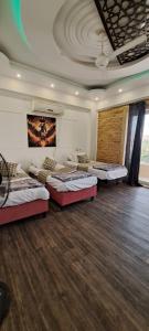 a room with four beds in it with a ceiling at Egypt Soul hotel retreat in Luxor