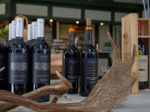 three bottles of wine sitting on a table with antlers at De Spaarbankhoeve in Fluitenberg