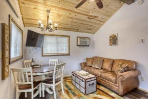a living room with a couch and a table at Cozy Creekside Retreat in Keystone