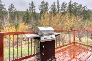 a grill sitting on a deck with a fence at Cozy Creekside Retreat in Keystone