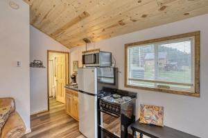 a kitchen with a refrigerator and a microwave at Cozy Creekside Retreat in Keystone