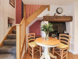 a dining room with a table and chairs and stairs at The Farmhouse Kitchen in Ripon +11 photos