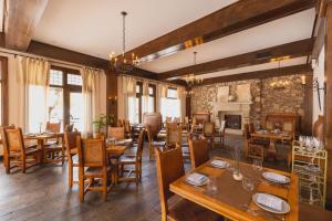 a restaurant with wooden tables and chairs and a fireplace at Hotel St Francis in Santa Fe