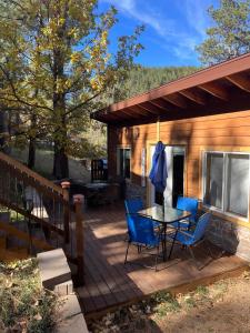 a wooden deck with a table and chairs on it at Bullion Street Hideaway in Keystone